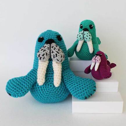 Picture of front view of three different Walrus crocheted from same pattern